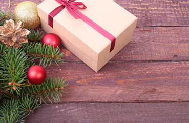 Naklejka na ściany i meble Christmas decoration fir tree with gift box and many balls, on wooden board