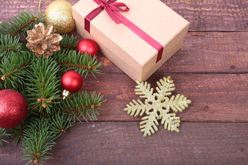 Naklejka na ściany i meble Christmas decoration fir tree with gift box and many balls, on wooden board