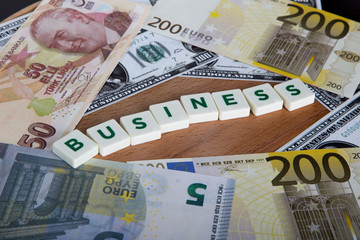Business Word with Letters Among Banknotes
