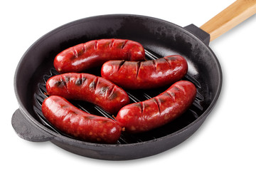 Traditional fragrant meat fried sausages in a cast-iron frying p