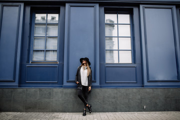 portrait of a young beautiful fashionable woman wearing sunglasses. A model in a stylish...