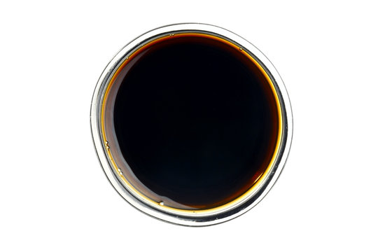 Soy sauce in the small glass bowl. Isolated