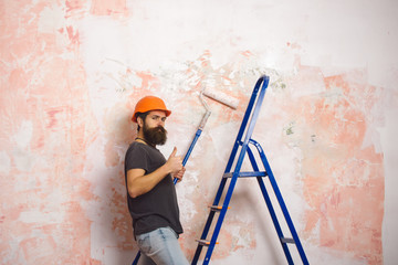 Man with long beard on shouting face in hard hat.