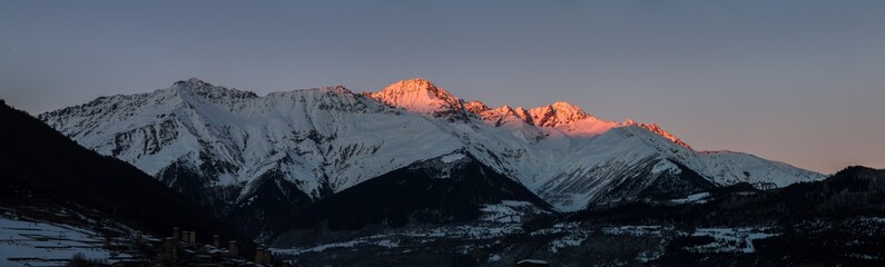 Panorama of snow mountain in winter time, sunset.