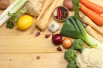 Fresh vegetables on light wooden background. Mockup for menu or recipe. Top view with copy space