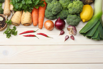 Fresh vegetables on white wooden background. Mockup for menu or recipe. Top view with copy space