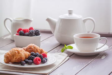 European breakfast tea coffee milk croissant fresh berries morning