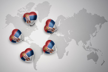 five hearts with national flag of serbia on a world map background.