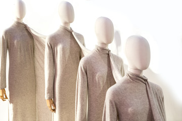 Fancy clothing on mannequins in a fashion store.