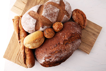 bakery concept with bread and bread rolls on white background.