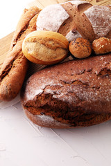 bakery concept with bread and bread rolls on white background.