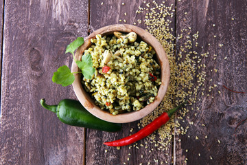 Bowl with homemade Bulgur Salad on wooden background.