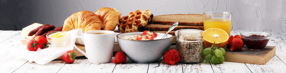 Breakfast served with coffee, orange juice, croissants, cereals and fruits. Balanced diet