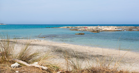 Wild beach with white sand and turquoise transparent sea, right out the city of Otranto, Puglia, Italy.