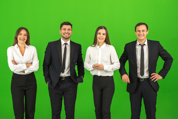 The four happy people stand on the green background