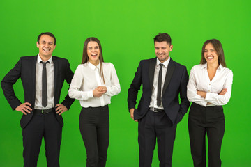 The four happy people stand on the green background