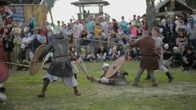 Knight with a sword runs and falls on the battlefield