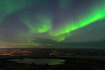 In the night sky the Aurora reflected in a lake.