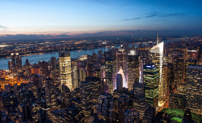 Aerial view of Manhattan New York skyline at sunset, during the blue hours, with lights of skyscrapers turning on.