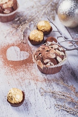 Tasty chocolate cupcake with sweets and winter decoration