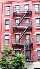 Series of black windows framed with red wall with metal stairs - Vintage industrial architecture