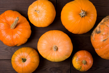 orange pumpkin on dark wooden background