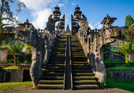 Carved stone gate of Besakih with dragons and stairs leading up