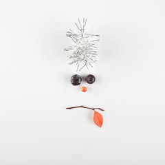 christmas face made of berries and tree branch.Minimal christmas concept.