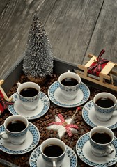 Cups with coffee,pattern design concept-cups of coffee on wooden tray and christmas decorations.