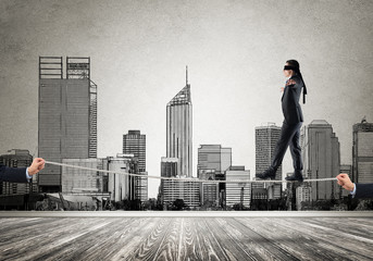 Fototapeta premium Business concept of risk support and assistance with man balancing on rope