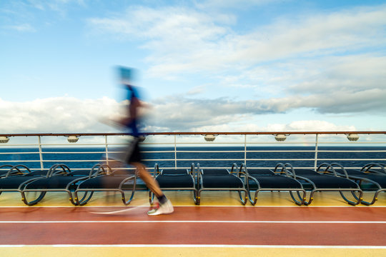 Blurred Joggers on cruise ship running track