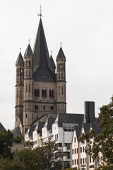 Fototapeta premium COLOGNE, GERMANY - SEPTEMBER 11, 2016: Colorful houses in Bavarian style and the Romanesque Catholic church 