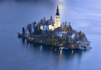 old church on the island in twilight time in Slovenia