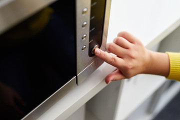 Woman uses a microwave oven