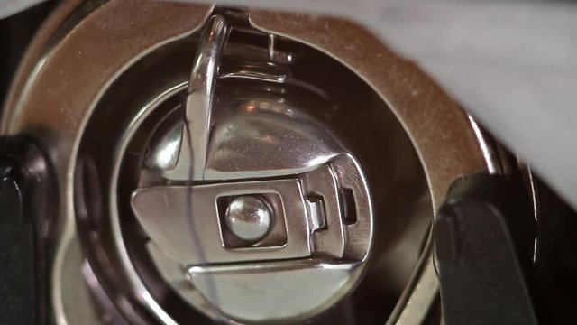 installation of a bobbin case in the shuttle of a sewing machine