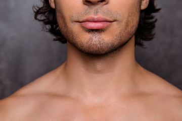 Close up cropped shot of nude hot guy`s bristle, chin, has perfect skin and hair, isolated on grey...