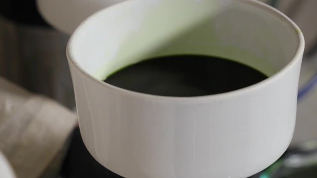 Lab worker filters marijuana oil.