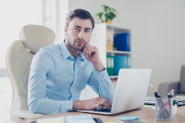 Rich successful and experienced boss of a large famous company is typing a letter to his business clients, he is sitting at the table in his office
