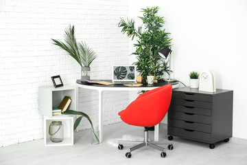 Modern room interior with laptop on table