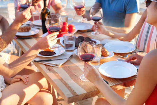 Young people having barbecue party at table