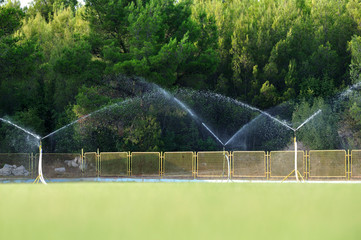 Sprinklers on the sports field. © konik60