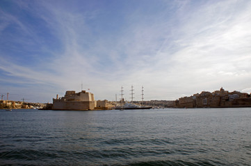 Fototapeta na wymiar Panorama of Grand Harbor and Birgu (Vittoriosa) - Three Cities in Malta with Fort Saint Angelo and luxury yachts
