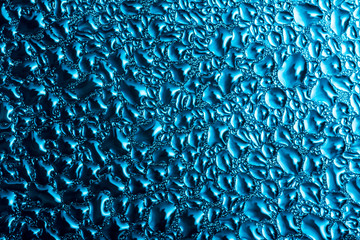 Drops of water on a foggy window close-up macro texture abstraction background.