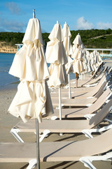 Beds and umbrellas on tropical beach in st johns, antigua