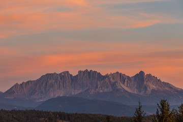 Amazing colorful clouds during autumnal sunset over Latemar summit, Alto Adige/South Tyrol, Italy