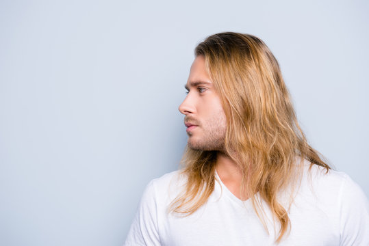 Close Up Side View Photo Of  Handsome Young Man With Bristle And Long Blonde Hair, Isolated On Grey Background