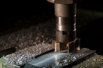 The old milling machine mills the part. There is a dural shaving around it. The working process
