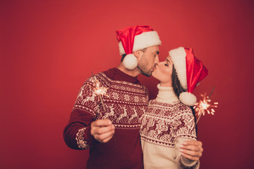 Fototapeta premium Adorable, lovely, sensual cute partners in knitted traditional x mas costumes with ornament hold sparkles and kiss, winter, noel, x mas miracle, holy spirit, true feelings