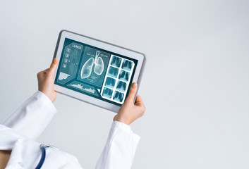 Close of female doctor hands working with tablet pc computer