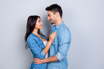 Fototapeta premium Concept of romantic relationship between man and woman. with bronze skin woman and handsome man are standing face to face and are going to kiss each other, isolated on grey background